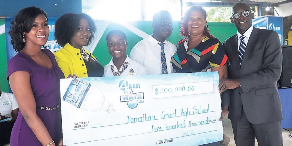 The WATA team presents a $500,000 cheque